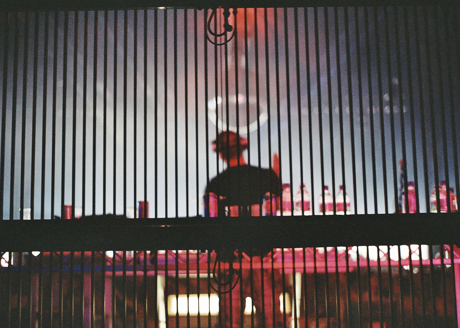 Slats in a wall with a bartender in the background as an example of vertical lines in photography