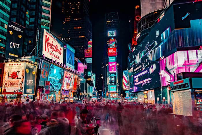 A busy cityscape with bright lights at night