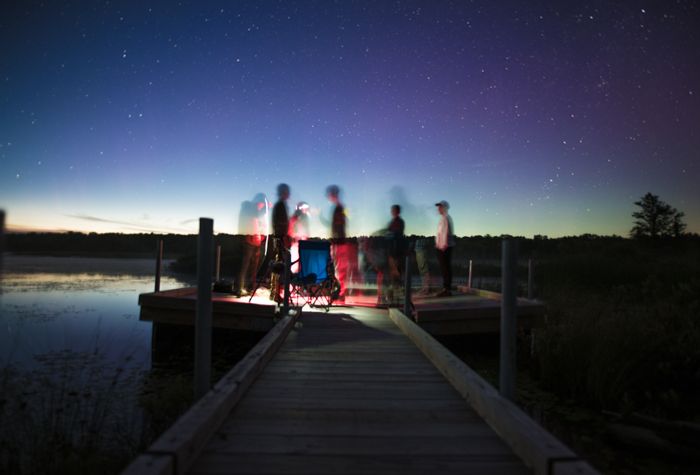 photo of a group of people on a pier with slow sync flash