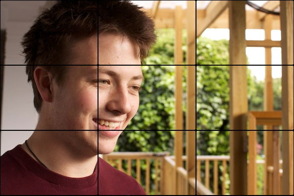 A shot of a man looking off camera with wood as an Interesting Background