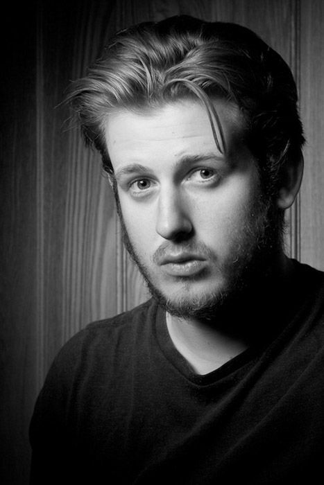 Black and white headshot photography of a young male model