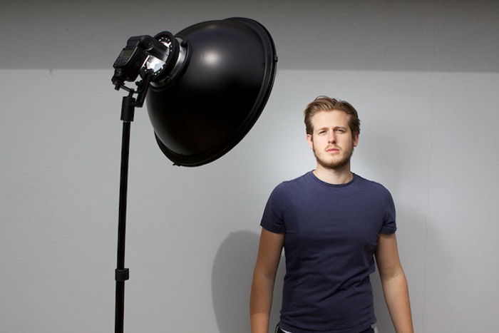 Studio set up for lack and white headshot photography of a young male model