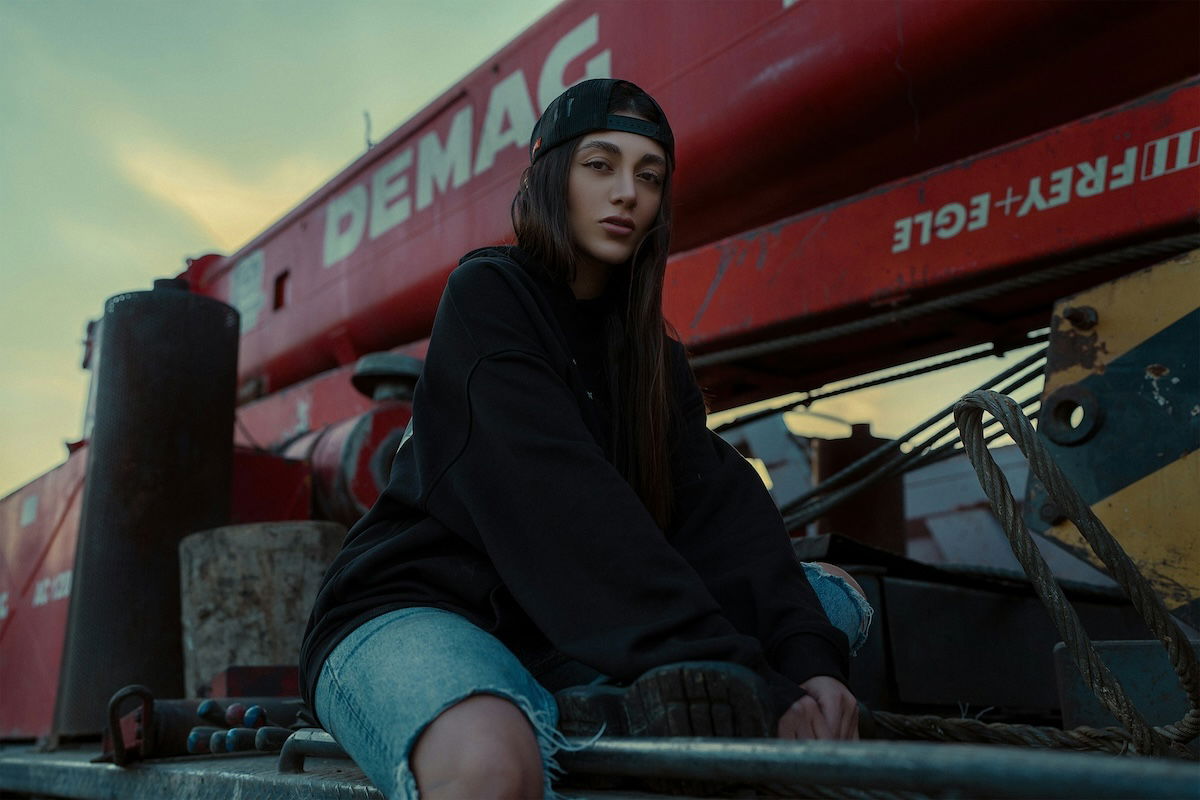 Woman posing at dusk with many triangle shapes in the background