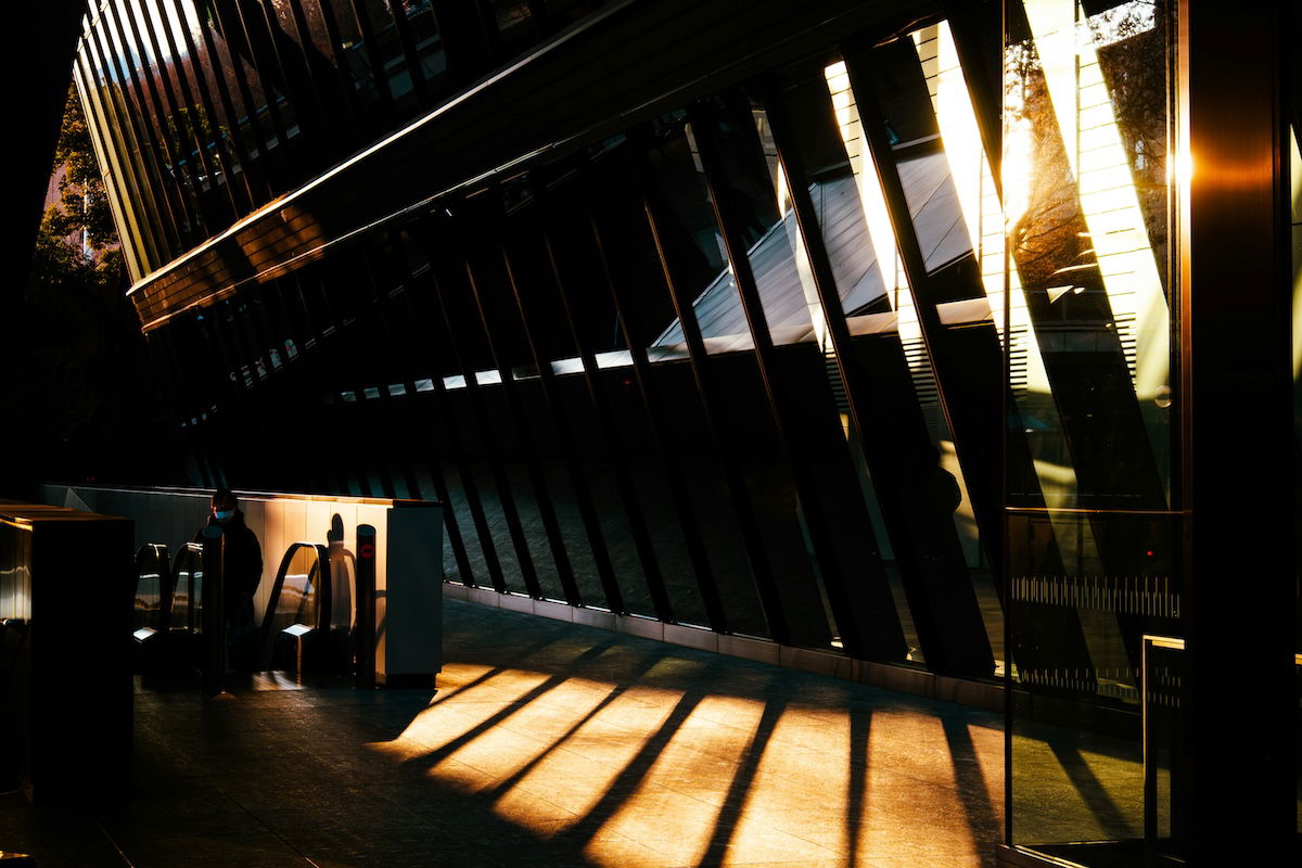 The interior of a modern building with glass windows, shadows, and light showing triangles in photography