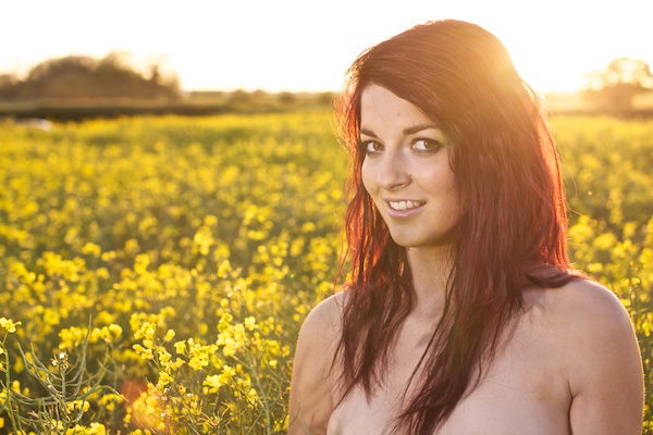 Photo of a young woman in the field of yellow flowers demonstrating editing with definition