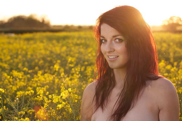 Photo of a young woman in the field of yellow flowers demonstrating editing with exposure