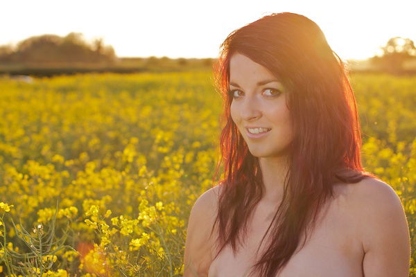 Photo of a young woman in the field of yellow flowers demonstrating editing with highlights