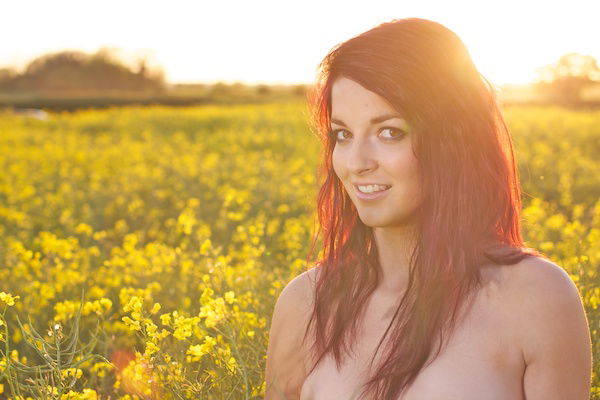 Photo of a young woman in the field of yellow flowers demonstrating editing with shadows