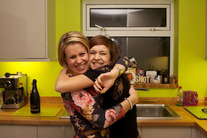 Cute portrait of two friends hugging at a party