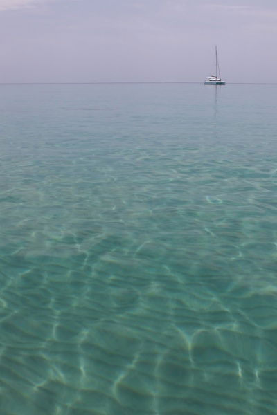 large amount of water and a single boat way off to the edge of the photo.