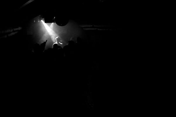 dramatic lighting on a performer in a crowd