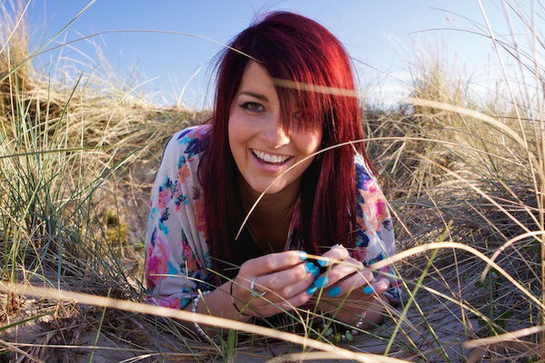 Central positioning on a girl who is smiling at the camera with surrounding detail