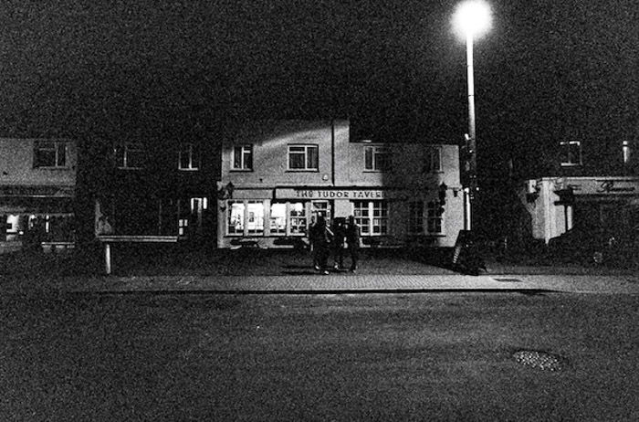 A dark grainy street photography shot