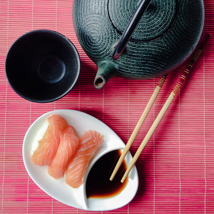 An overhead shot of sushi, teapot and tea cup for still life photography