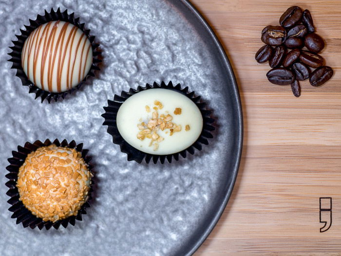 A focus stacked bird’s-eye view of Belgian pralines on a metal plate