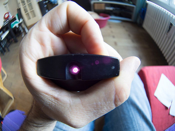 A close up of a hand holding a tv remote control for an infrared photography test