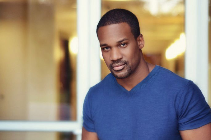 A portrait photo of a male model indoors