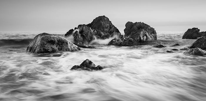 Black and white image of rocks at the seaside showing beautiful contrast