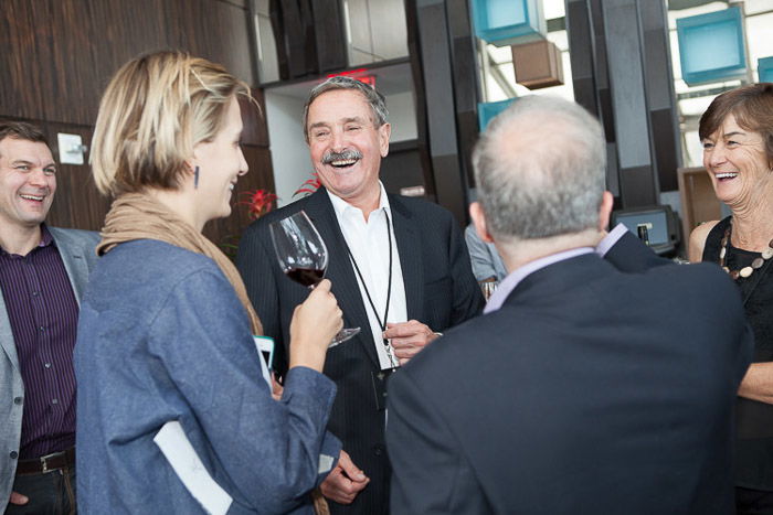 A candid shot of a group chatting at a corporate event 