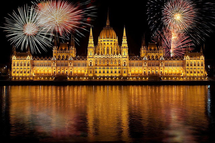 Stunning fireworks photograph of multiple large bursts over Budapest parliament building