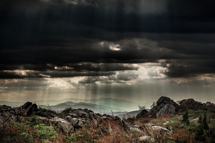 Dramatic Weather: Shafts of light coming down on hills through heavy cloud cover