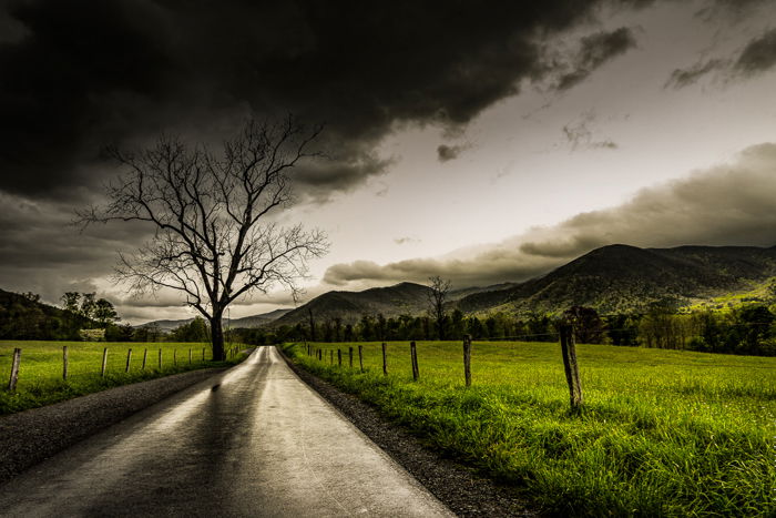 Dramatic Weather: Dusky sky over fields and a road after a rainstorm