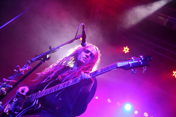 The lead singer of Anathema, backlit by a purple stage light.