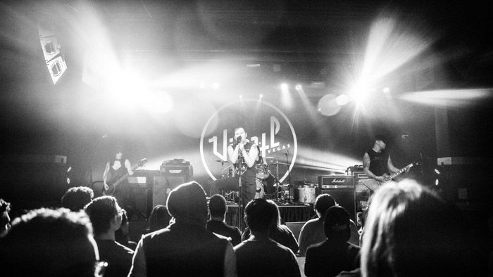 The crowd and band in a black and white photograph of There is No Us