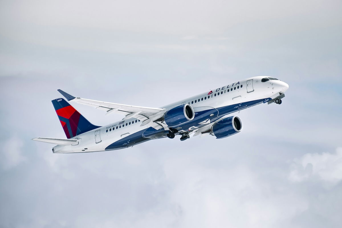 A Delta Airbus A220 taking off into the clouds