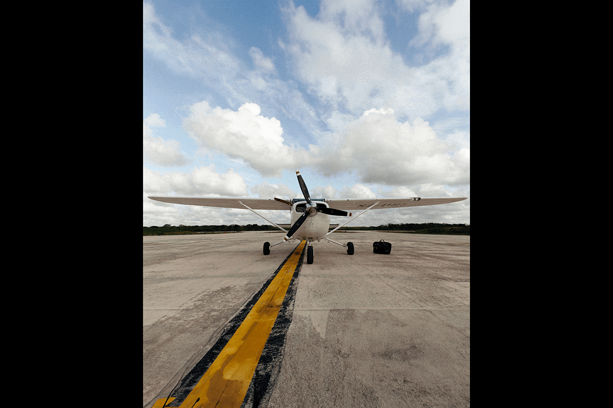 A parked planed with clouds as a background as an example of aviation photography