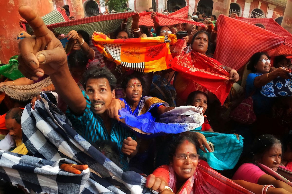 A group of people reaching and ready to receive something as an example of eyeline photography