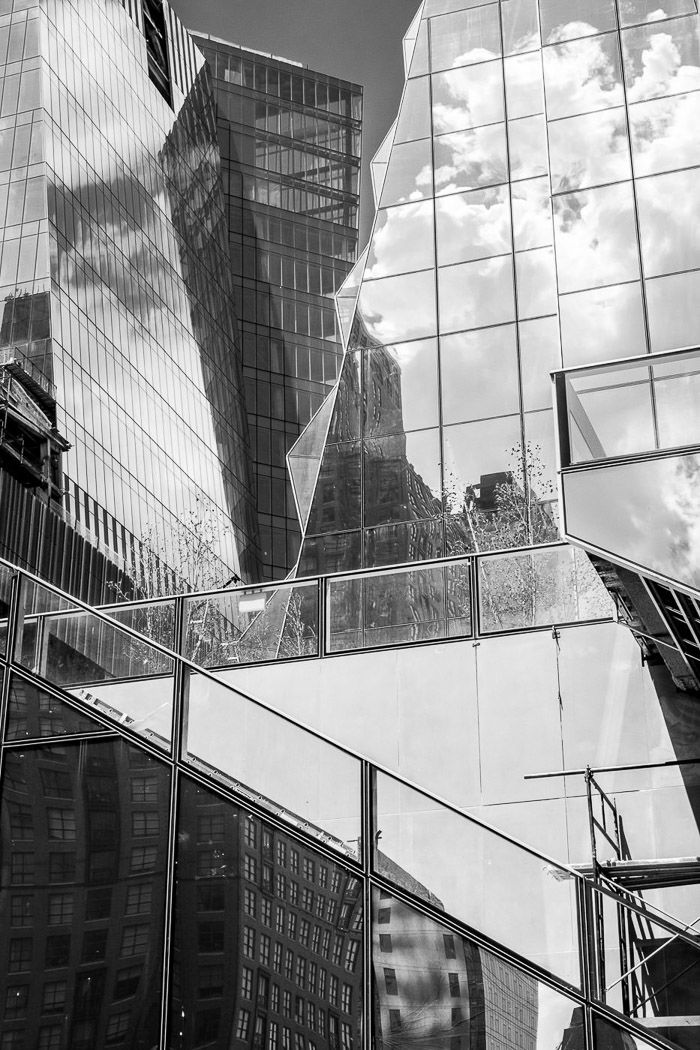 Glass-walled buildings create a stunning chain of reflections twisting contrasts and textures.