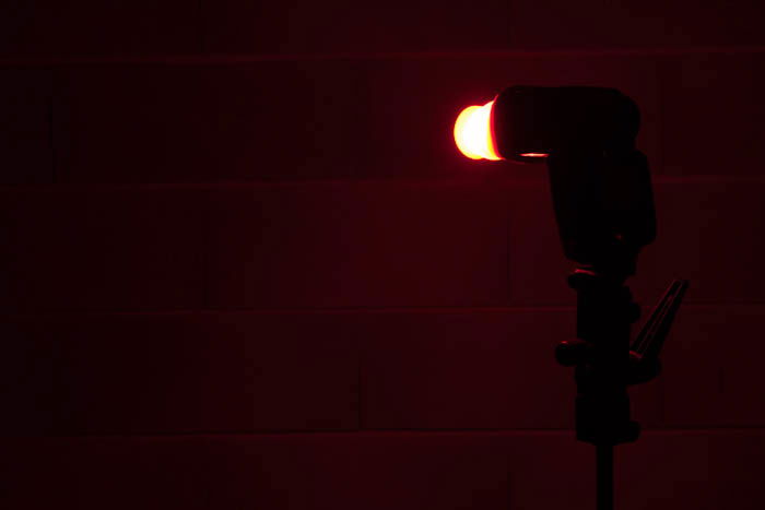 A silicone collapsible cup used as a color diffuser on a compact flash as a DIY speedlight modifier