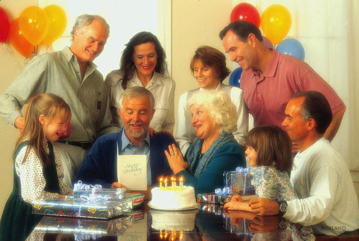 A group of people gathered around a dining table. 