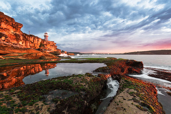 Seascape Photography of a lighthouse at sunrise 