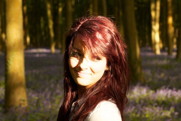 A portrait of a female model in a forest