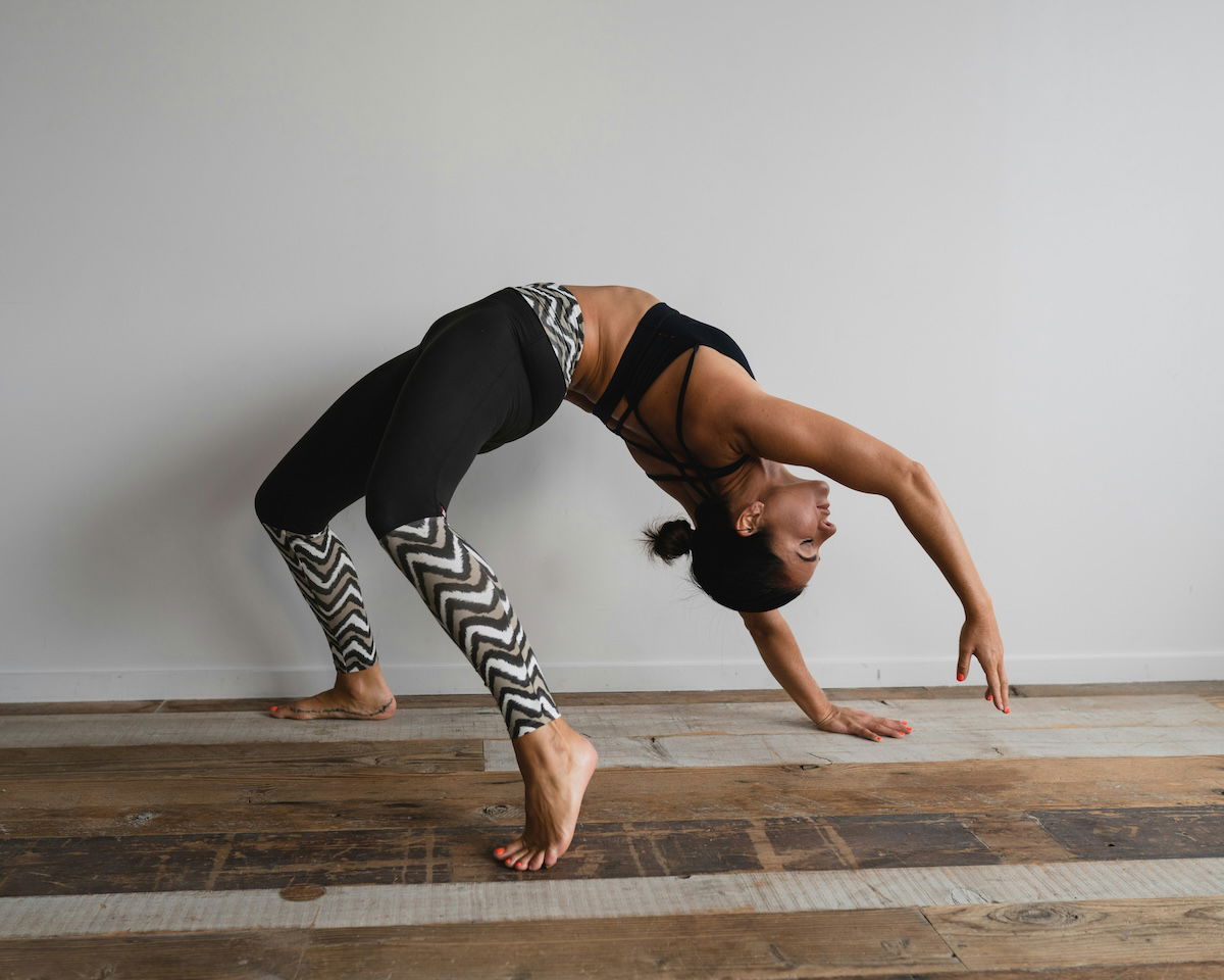 Yogini doing a backbend pose inside as an example of yoga photography