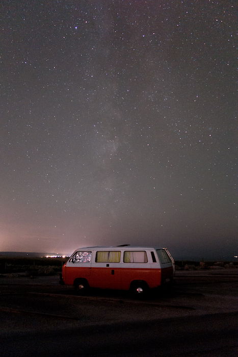 red and white caravan under the starry sky astrophotography