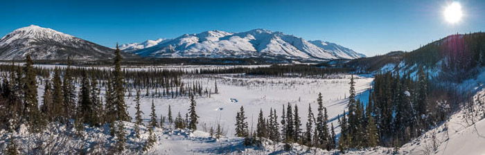 A stunning panoramic photograph of a winter landscape taken in Wiseman, Alaska