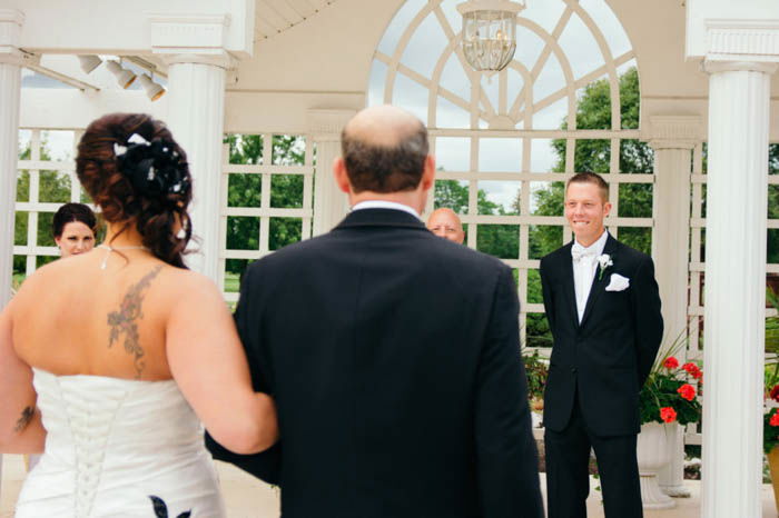 wedding photography shot of the bride and father of bride walking down the aisle