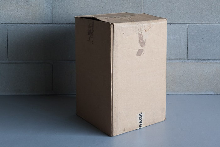 A cardboard box beside a stone wall for making a diy lightbox