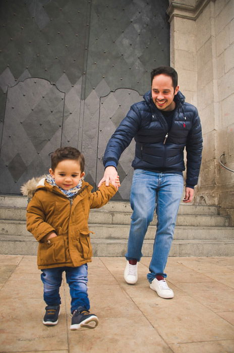 A father and son playfully running towards the camera - family portrait poses