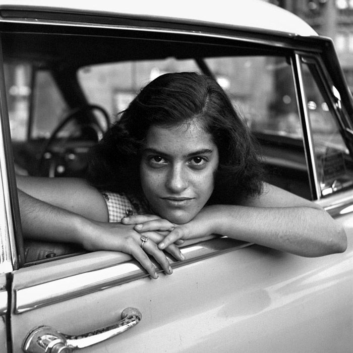 A black and white portrait of a girl in a car by Vivian Maier female photographer