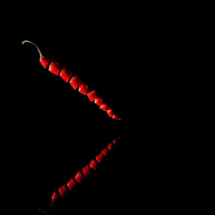 floating pepper slices against black background