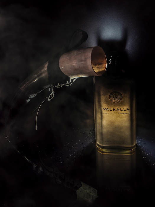 Atmospheric photo of a bottle of Finnish liquor beside a viking horn 