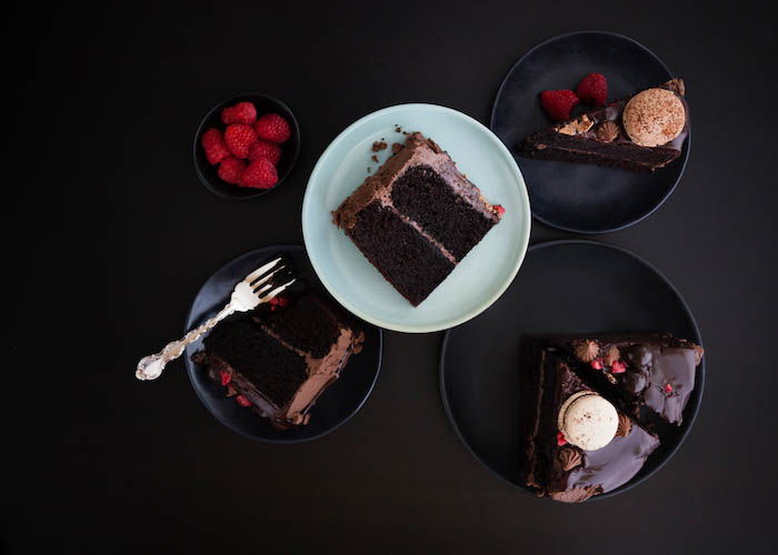 Chocolate ganache layer cake slices on dark background