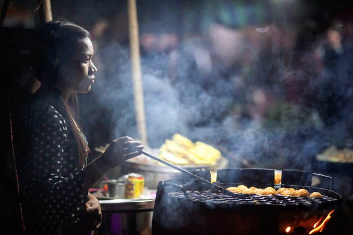 A street food vendor at work at night