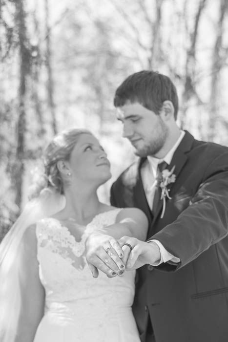 Black and white wedding portrait of the couple posing outdoors