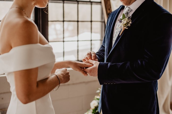 Close up of the bride and Groom holding hands during a wedding ceremony