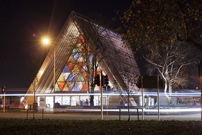 Front view of the brightly colored Transitional Cathedral (aka 'Cardboard Cathedral'), New Zealand, at night. Architecture Photography.